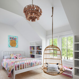 Réalisation d'une chambre d'enfant de 4 à 10 ans champêtre de taille moyenne avec un mur blanc, un sol en bois clair, un sol marron et un plafond voûté.