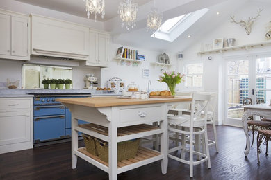 Country kitchen in Surrey with shaker cabinets and an island.