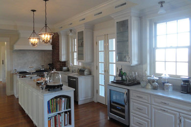 Example of a transitional medium tone wood floor kitchen design in Other with a farmhouse sink, white cabinets, solid surface countertops and two islands