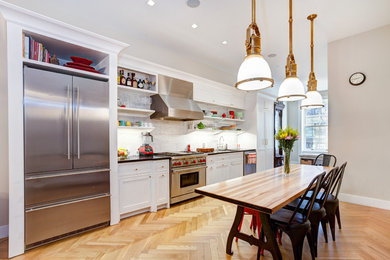 Example of a large single-wall light wood floor eat-in kitchen design in New York with a drop-in sink, shaker cabinets, white cabinets, multicolored backsplash, stainless steel appliances, no island, granite countertops and ceramic backsplash