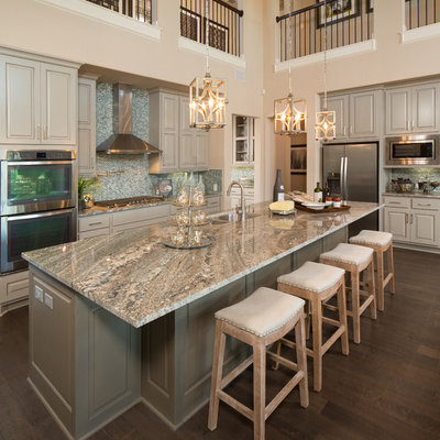 Inspiration for a transitional l-shaped dark wood floor kitchen remodel in Austin with an undermount sink, raised-panel cabinets, gray cabinets, blue backsplash, mosaic tile backsplash, stainless steel appliances, an island and gray countertops