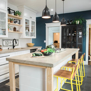 Design ideas for a small country single-wall kitchen in New York with an undermount sink, white cabinets, concrete benchtops, white splashback, ceramic splashback, stainless steel appliances, slate floors, with island, grey floor, shaker cabinets and grey benchtop.