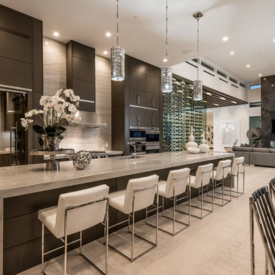 Open concept kitchen - large contemporary beige floor and limestone floor open concept kitchen idea in Las Vegas with an undermount sink, flat-panel cabinets, dark wood cabinets, stainless steel appliances, an island, granite countertops, gray backsplash, stone slab backsplash and beige countertops