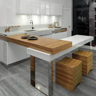 Modern eat-in kitchen designs - Inspiration for a modern u-shaped ceramic tile eat-in kitchen remodel in New York with flat-panel cabinets and white cabinets