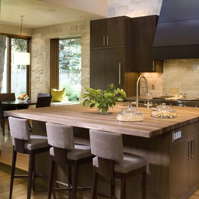 Mountain style kitchen photo in Denver with wood countertops and limestone backsplash