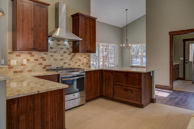Inspiration for a mid-sized transitional u-shaped porcelain tile and beige floor eat-in kitchen remodel in Albuquerque with recessed-panel cabinets, dark wood cabinets, granite countertops, beige backsplash, porcelain backsplash, stainless steel appliances and a peninsula
