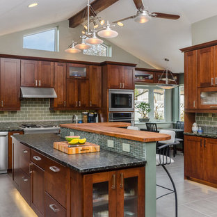 Idee per una grande cucina chic con ante in stile shaker, paraspruzzi verde, elettrodomestici in acciaio inossidabile, lavello a vasca singola, ante in legno scuro, top in granito, paraspruzzi con piastrelle a mosaico, pavimento in gres porcellanato, pavimento grigio e top grigio