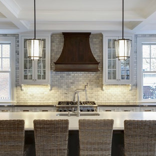 Design ideas for a mid-sized traditional galley eat-in kitchen in Minneapolis with an undermount sink, recessed-panel cabinets, beige cabinets, quartzite benchtops, grey splashback, subway tile splashback, panelled appliances, dark hardwood floors and with island.