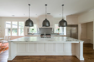 Enclosed kitchen - mid-sized transitional single-wall dark wood floor and brown floor enclosed kitchen idea in Atlanta with an undermount sink, recessed-panel cabinets, white cabinets, marble countertops, white backsplash, subway tile backsplash, stainless steel appliances and an island