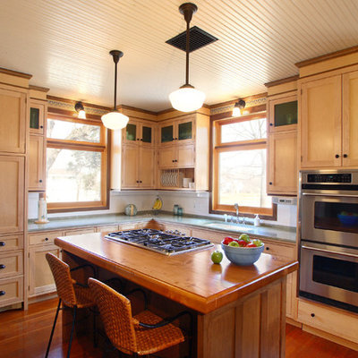 Inspiration for a craftsman l-shaped medium tone wood floor enclosed kitchen remodel in Minneapolis with an undermount sink, shaker cabinets, light wood cabinets, granite countertops, white backsplash, subway tile backsplash, stainless steel appliances and an island