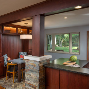 Photo of a mid-sized midcentury galley open plan kitchen in Columbus with an undermount sink, flat-panel cabinets, dark wood cabinets, granite benchtops, grey splashback, glass tile splashback, stainless steel appliances, vinyl floors and a peninsula.
