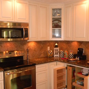 Design ideas for a mid-sized traditional u-shaped eat-in kitchen in Houston with an undermount sink, raised-panel cabinets, beige cabinets, granite benchtops, brown splashback, porcelain splashback, stainless steel appliances and medium hardwood floors.