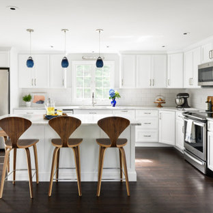 Mid-sized transitional eat-in kitchen appliance - Inspiration for a mid-sized transitional l-shaped vinyl floor and brown floor eat-in kitchen remodel in Boston with white cabinets, quartzite countertops, white backsplash, subway tile backsplash, stainless steel appliances, an island and white countertops