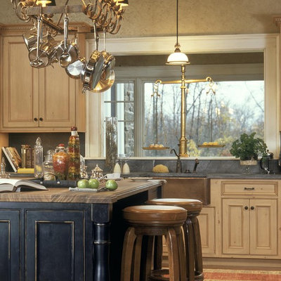 Elegant kitchen photo in New York with a farmhouse sink, beaded inset cabinets, distressed cabinets, soapstone countertops, gray backsplash and stone slab backsplash