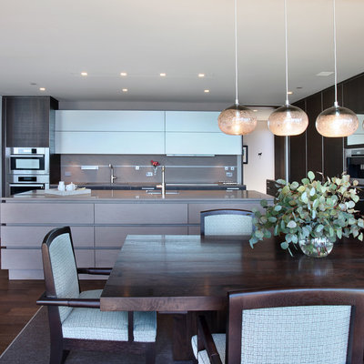 Example of a trendy l-shaped eat-in kitchen design in Orange County with flat-panel cabinets, dark wood cabinets and concrete countertops