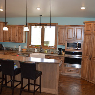 Farmhouse kitchen inspiration - Kitchen - cottage u-shaped vinyl floor kitchen idea in Other with a farmhouse sink, raised-panel cabinets, light wood cabinets, quartzite countertops, stainless steel appliances and an island