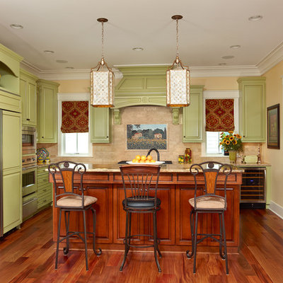 Inspiration for a timeless kitchen remodel in Charleston with granite countertops, green cabinets, raised-panel cabinets, paneled appliances, an island and beige backsplash