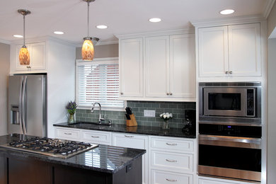 Small trendy kitchen photo in Milwaukee with white cabinets and stainless steel appliances