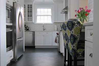 リッチモンドにある高級なおしゃれなキッチン (白いキャビネット、白いキッチンパネル、セラミックタイルのキッチンパネル、シルバーの調理設備、セラミックタイルの床) の写真
