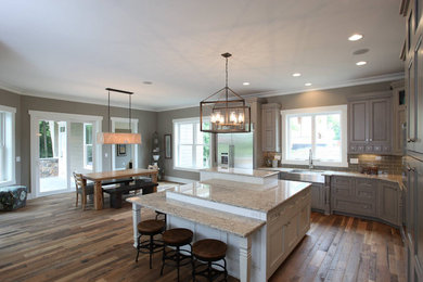 Example of an eat-in kitchen design in Columbus with recessed-panel cabinets, gray cabinets and an island