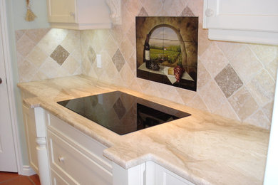 Example of a kitchen design in Calgary with marble countertops