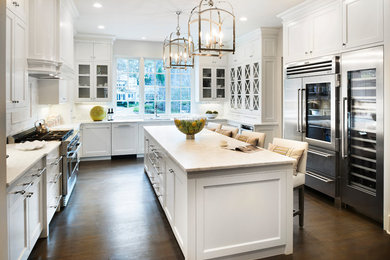 Large transitional l-shaped dark wood floor and brown floor enclosed kitchen photo in Atlanta with an undermount sink, shaker cabinets, white cabinets, marble countertops, white backsplash, subway tile backsplash, stainless steel appliances and an island