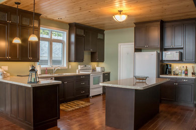 Inspiration for a mid-sized craftsman u-shaped medium tone wood floor and brown floor eat-in kitchen remodel in Toronto with a double-bowl sink, recessed-panel cabinets, brown cabinets, granite countertops, white appliances, an island and beige countertops