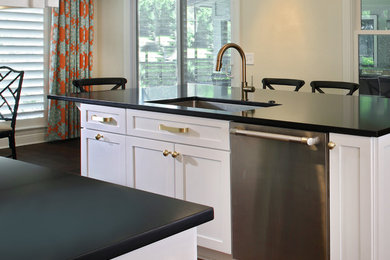 Example of a transitional dark wood floor kitchen design in Jacksonville with a drop-in sink, shaker cabinets, white cabinets, quartzite countertops, stainless steel appliances and an island