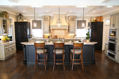 Example of a mid-sized transitional single-wall dark wood floor eat-in kitchen design in Indianapolis with raised-panel cabinets, gray cabinets, granite countertops, beige backsplash, paneled appliances, an island, an undermount sink and ceramic backsplash