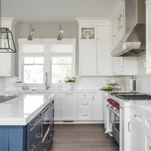 Transitional kitchen remodeling - Kitchen - transitional l-shaped medium tone wood floor kitchen idea in Indianapolis with an undermount sink, recessed-panel cabinets, white cabinets, white backsplash, stainless steel appliances and an island