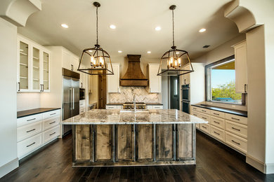 Example of a large tuscan u-shaped dark wood floor eat-in kitchen design in Austin with a single-bowl sink, white cabinets, granite countertops, white backsplash, mosaic tile backsplash, stainless steel appliances, an island and shaker cabinets