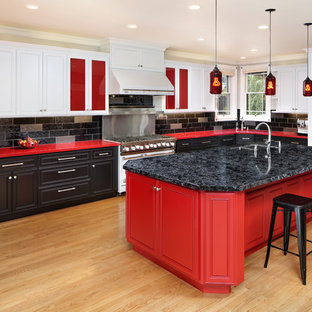 Transitional u-shaped kitchen in San Francisco with a double-bowl sink, beaded inset cabinets, red cabinets, black splashback, panelled appliances, light hardwood floors, with island, beige floor and red benchtop.