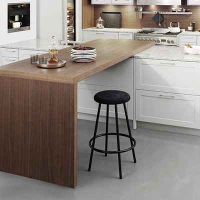 Example of a large minimalist l-shaped concrete floor eat-in kitchen design in New York with shaker cabinets, white cabinets, laminate countertops, brown backsplash, stainless steel appliances, a peninsula and a farmhouse sink