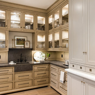 Photo of a traditional l-shaped kitchen pantry in Salt Lake City with an integrated sink, recessed-panel cabinets, distressed cabinets, grey splashback, light hardwood floors and beige floor.
