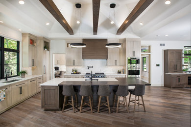 Huge minimalist l-shaped brown floor and dark wood floor open concept kitchen photo in Grand Rapids with an undermount sink, flat-panel cabinets, light wood cabinets, white backsplash, marble backsplash, stainless steel appliances, an island, quartzite countertops and white countertops