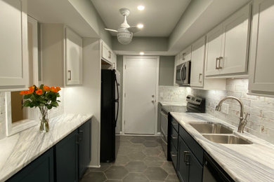 Inspiration for a mid-sized modern galley ceramic tile, multicolored floor and vaulted ceiling enclosed kitchen remodel in Atlanta with a double-bowl sink, shaker cabinets, white cabinets, marble countertops, white backsplash, ceramic backsplash, stainless steel appliances, no island and white countertops