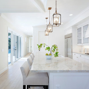Traditional kitchen photos - Kitchen - traditional light wood floor kitchen idea in Miami with a farmhouse sink, shaker cabinets, white cabinets, white backsplash, subway tile backsplash, stainless steel appliances and an island