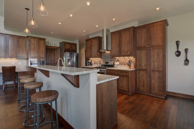 Mid-sized transitional l-shaped dark wood floor and brown floor open concept kitchen photo in Albuquerque with shaker cabinets, dark wood cabinets, granite countertops, beige backsplash, mosaic tile backsplash, stainless steel appliances and an island