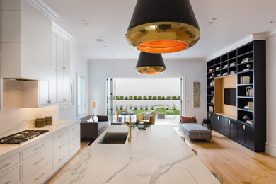 Huge minimalist kitchen photo in San Francisco with beaded inset cabinets, white cabinets, quartz countertops and an island