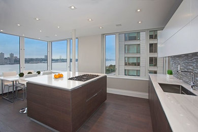 This is an example of a modern l-shaped kitchen/diner in New York with an island.