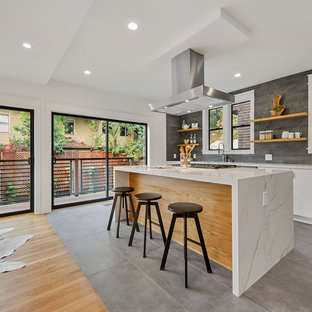 Large contemporary open concept kitchen appliance - Inspiration for a large contemporary l-shaped gray floor open concept kitchen remodel in San Francisco with an undermount sink, flat-panel cabinets, white cabinets, marble countertops, stainless steel appliances, an island, gray backsplash and white countertops