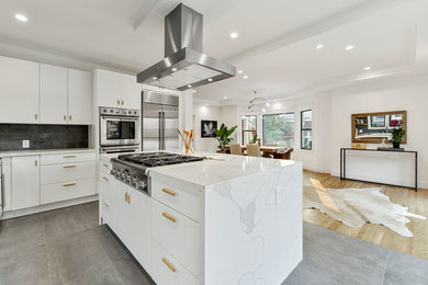 Inspiration for a large contemporary l-shaped gray floor open concept kitchen remodel in San Francisco with an undermount sink, flat-panel cabinets, white cabinets, marble countertops, stainless steel appliances, an island, gray backsplash and white countertops