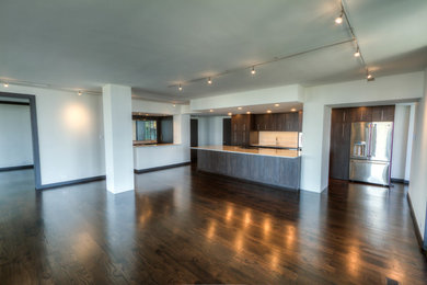 Example of a large minimalist galley dark wood floor eat-in kitchen design in Dallas with a single-bowl sink, flat-panel cabinets, dark wood cabinets, marble countertops, white backsplash, porcelain backsplash, stainless steel appliances and two islands