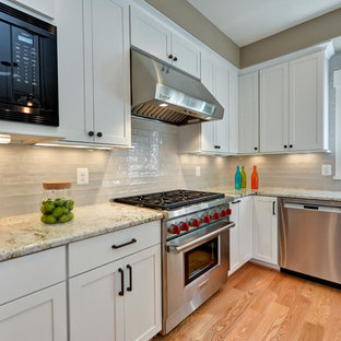 Transitional kitchen inspiration - Kitchen - transitional l-shaped light wood floor kitchen idea in DC Metro with shaker cabinets, white cabinets, gray backsplash, stainless steel appliances and an island
