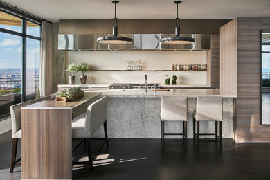 Inspiration for a mid-sized contemporary galley dark wood floor eat-in kitchen remodel in Chicago with an island, an undermount sink, flat-panel cabinets, light wood cabinets, solid surface countertops, white backsplash, stone slab backsplash and stainless steel appliances
