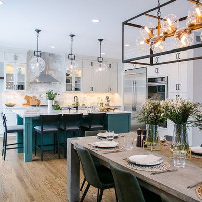 Example of a large transitional single-wall medium tone wood floor and brown floor eat-in kitchen design in Denver with an undermount sink, shaker cabinets, white cabinets, quartz countertops, multicolored backsplash, marble backsplash, stainless steel appliances, an island and white countertops
