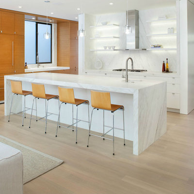 Example of a large trendy l-shaped light wood floor open concept kitchen design in San Francisco with open cabinets, white cabinets, white backsplash, paneled appliances, an island, an undermount sink, marble countertops and stone slab backsplash