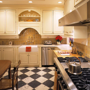 Inspiration for a traditional l-shaped eat-in kitchen in New York with stainless steel appliances, a farmhouse sink, beaded inset cabinets, light wood cabinets, granite benchtops, brown splashback, ceramic splashback, marble floors and multi-coloured floor.