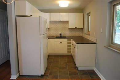 Example of a small country u-shaped ceramic tile kitchen design in Cincinnati with a single-bowl sink, beaded inset cabinets, white cabinets, laminate countertops, white backsplash, ceramic backsplash, white appliances and no island