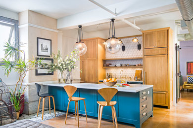 Inspiration for a contemporary galley concrete floor and brown floor open concept kitchen remodel in Los Angeles with a farmhouse sink, shaker cabinets, quartz countertops, white backsplash, paneled appliances, a peninsula, white countertops, turquoise cabinets and cement tile backsplash